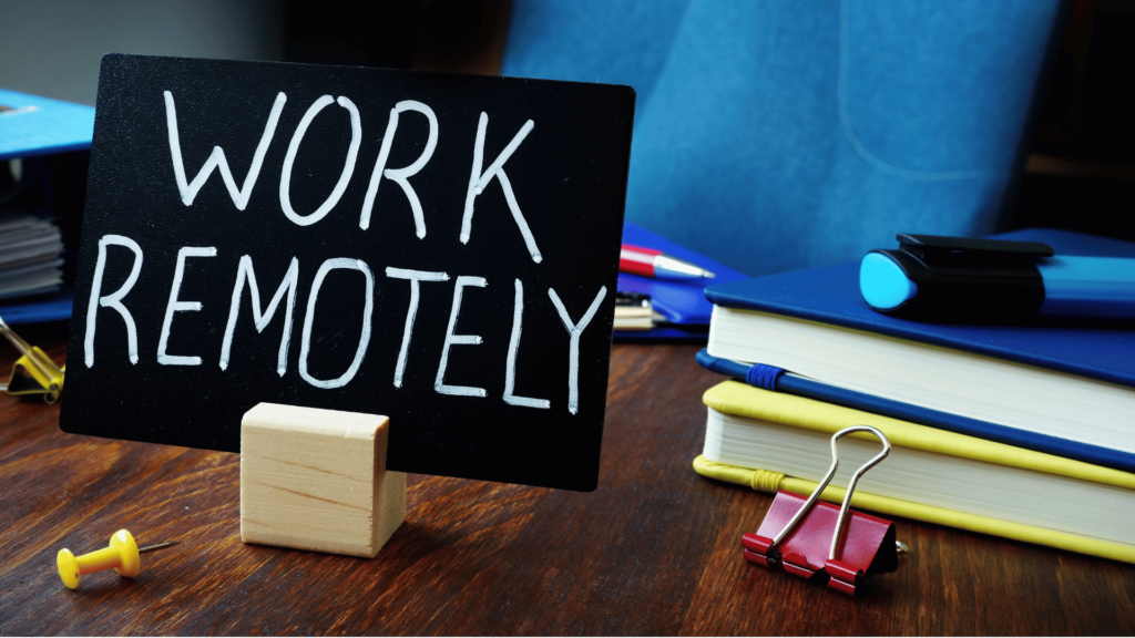 A minimalist workspace featuring a sleek laptop, a coffee cup, and headphones on a wooden desk, symbolizing productivity and remote work.